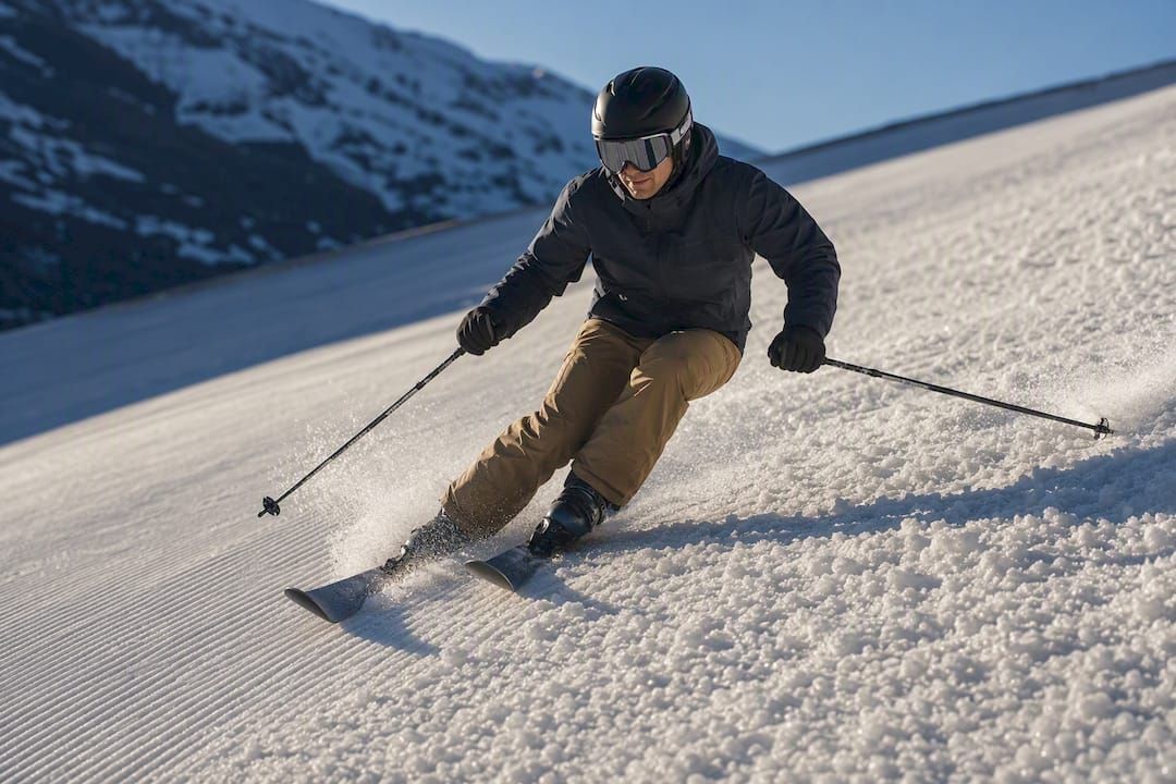 Skier turning through softened spring snow