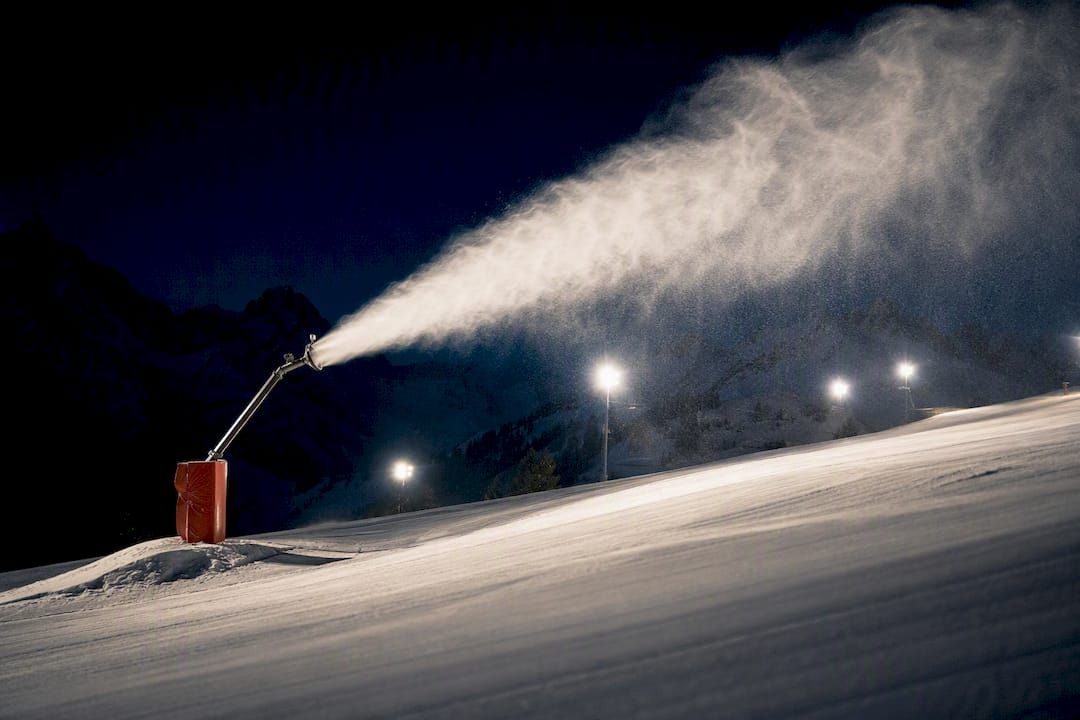 Snowmaking plume over a nighttime Alpine piste