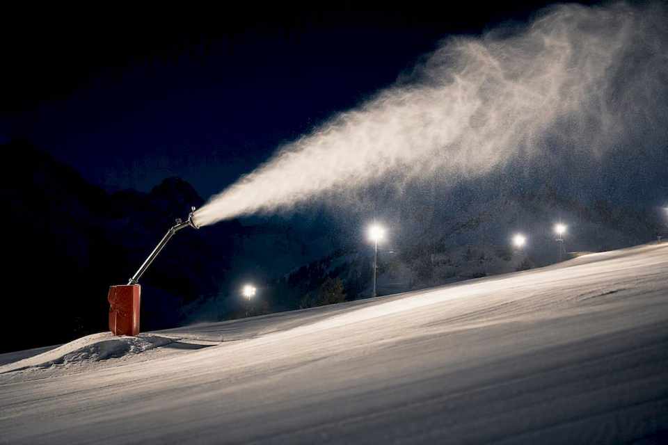 Snowmaking plume over a nighttime Alpine piste