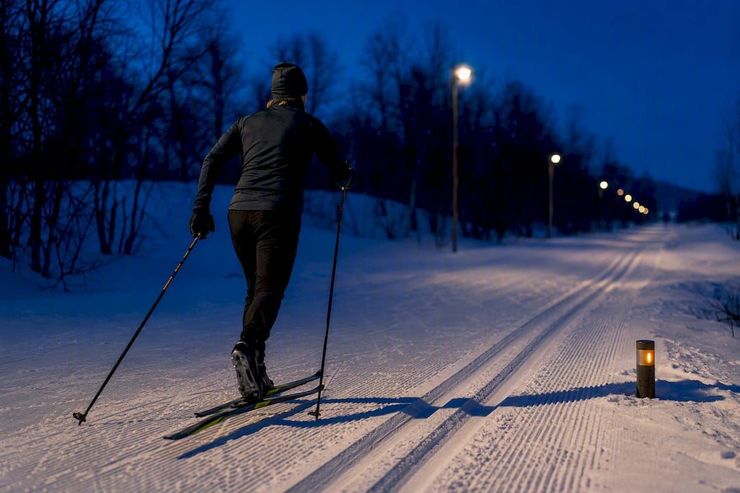 Cross-country skier on a floodlit Lapland track