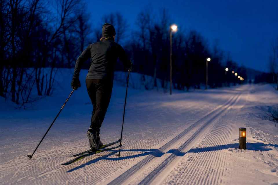 Cross-country skier on a floodlit Lapland track